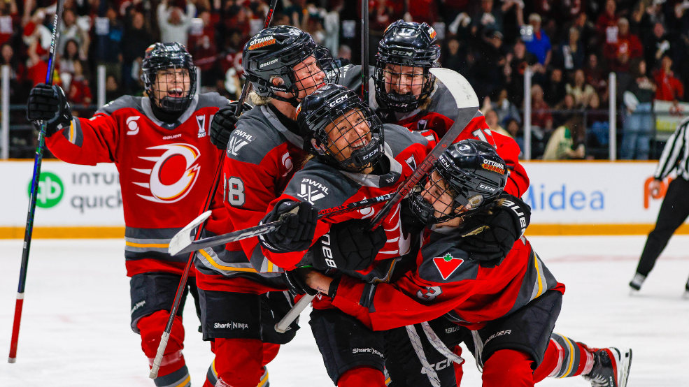 PWHL Ottawa Charge team members hug and celebrate win