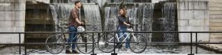 Cyclist crossing the Rideau Canal locks in fall